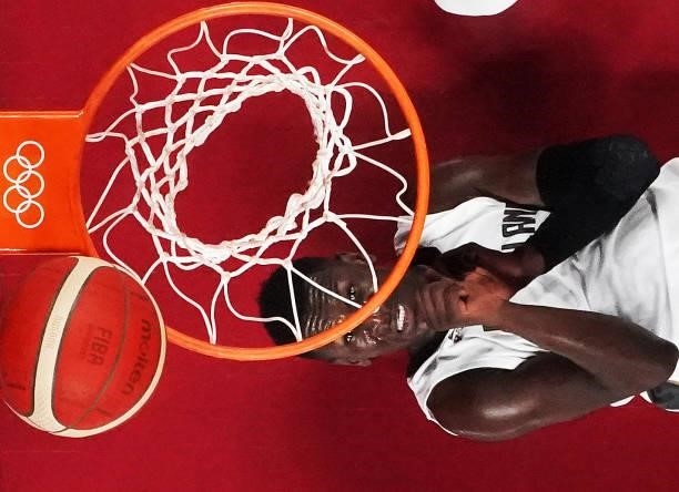 Isaac Bonga of Team Germany watches the ball while laying on the court against Italy during the first half on day two of the Tokyo 2020 Olympic Games...