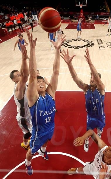 Simone Fontecchio and Achille Polonara of Team Italy go after a rebound against Germany during the first half on day two of the Tokyo 2020 Olympic...