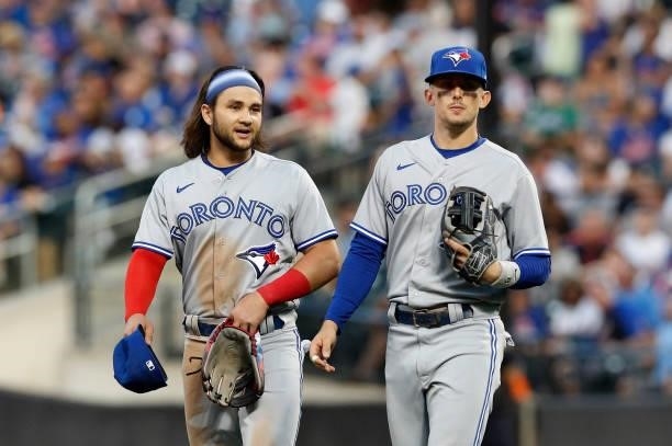 Bo Bichette and Cavan Biggio of the Toronto Blue Jays in action against the New York Mets at Citi Field on July 23, 2021 in New York City. The Mets...