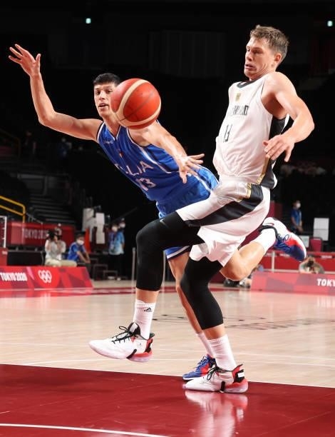 Simone Fontecchio of Team Italy and Moritz Wagner of Team Germany eye a loose ball during the second half on day two of the Tokyo 2020 Olympic Games...
