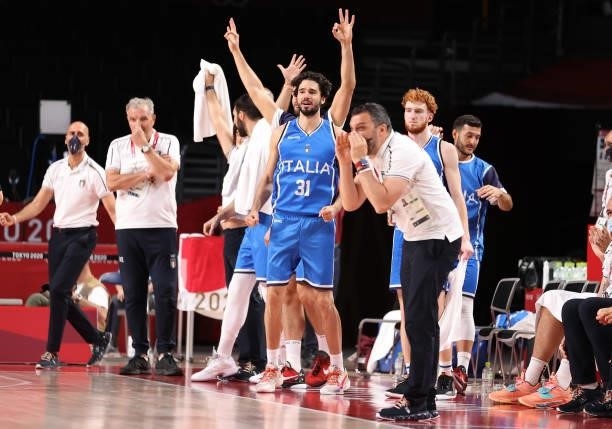 Members of Team Italy celebrate a three point basket against Germany during the second half on day two of the Tokyo 2020 Olympic Games at Saitama...