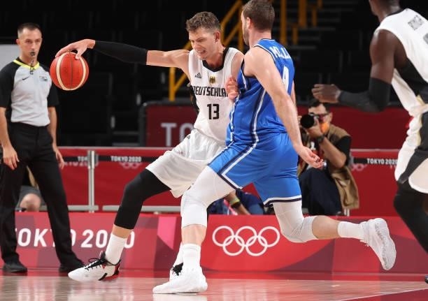 Moritz Wagner of Team Germany is defended by Nicolo Melli of Team Italy during the second half on day two of the Tokyo 2020 Olympic Games at Saitama...