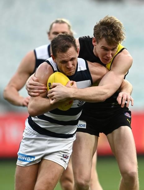 Joel Selwood of the Cats is tackled by Tom J. Lynch of the Tigers during the round 19 AFL match between Geelong Cats and Richmond Tigers at Melbourne...