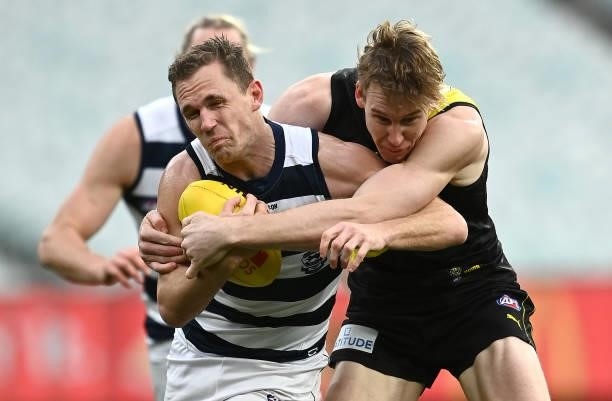 Joel Selwood of the Cats is tackled by Tom J. Lynch of the Tigers during the round 19 AFL match between Geelong Cats and Richmond Tigers at Melbourne...