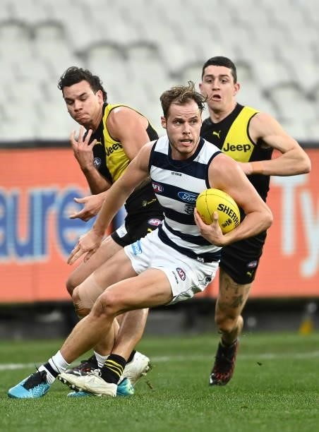Jake Kolodjashnij of the Cats breaks free of a tackle during the round 19 AFL match between Geelong Cats and Richmond Tigers at Melbourne Cricket...