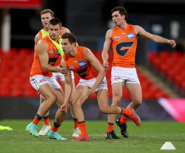 Josh Kelly of the GWS Giants warms up during the round 19 AFL match between Essendon Bombers and Greater Western Sydney Giants at Metricon Stadium on...