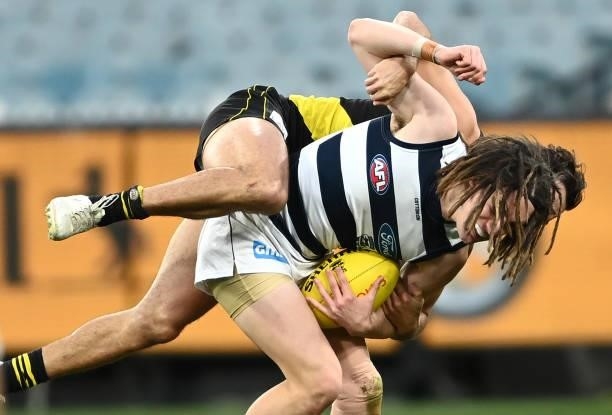Gryan Miers of the Cats is tackled during the round 19 AFL match between Geelong Cats and Richmond Tigers at Melbourne Cricket Ground on July 25,...