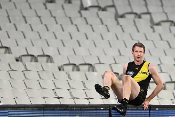 Dylan Grimes of the Tigers retrieves the ball from the grandstand during the round 19 AFL match between Geelong Cats and Richmond Tigers at Melbourne...