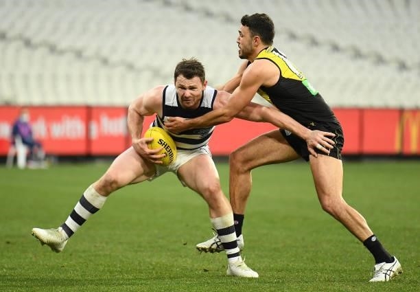 Patrick Dangerfield of the Cats is tackled by Shane Edwards of the Tigers during the round 19 AFL match between Geelong Cats and Richmond Tigers at...