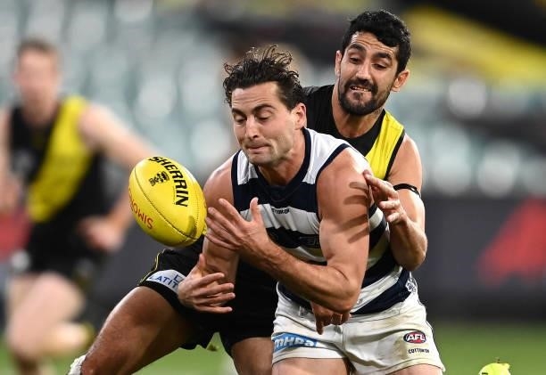 Luke Dahlhaus of the Cats is tackled by Marlion Pickett of the Tigers during the round 19 AFL match between Geelong Cats and Richmond Tigers at...