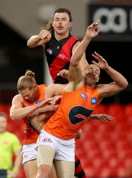 Sam Draper of Essendon and Shane Mumford of the GWS Giants compete for the ball during the round 19 AFL match between Essendon Bombers and Greater...