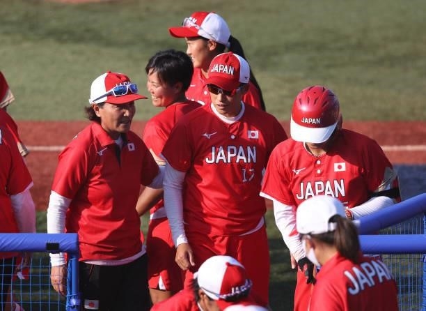 Yukiko Ueno and head coach Reika Utsugi walk to the dugout after their 1-0 win against Team Canada during the Softball Opening Round on day two of...