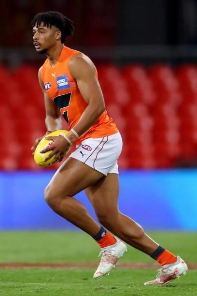 Connor Idun of the GWS Giants runs with the ball during the round 19 AFL match between Essendon Bombers and Greater Western Sydney Giants at Metricon...