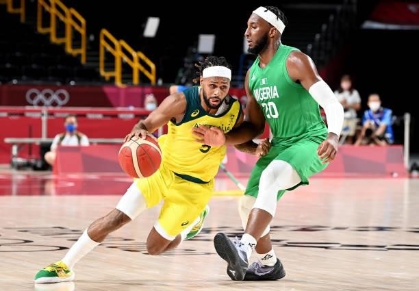 Patty Mills of Australia takes on the defence of Josh Okogie of Nigeria during the preliminary rounds of the Men's Basketball match between Australia...