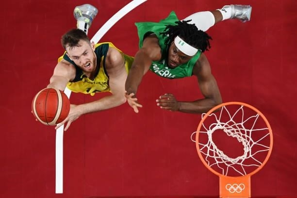 Nic Kay of Team Australia drives to the basket against Precious Achiuwa of Team Nigeria in the first half of their Men's Preliminary Round Group B...