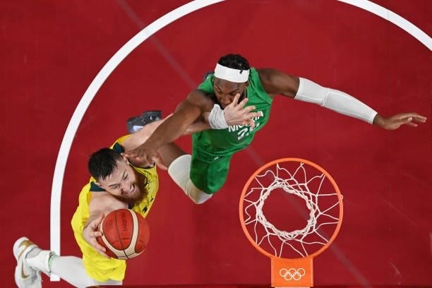 Aron Baynes of Team Australia drives to the basket against Josh Okogie of Team Nigeria in the first half of their Men's Preliminary Round Group B...
