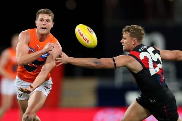Jacob Hopper of the GWS Giants handballs during the round 19 AFL match between Essendon Bombers and Greater Western Sydney Giants at Metricon Stadium...