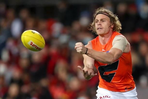 Adam Kennedy of the GWS Giants handballs during the round 19 AFL match between Essendon Bombers and Greater Western Sydney Giants at Metricon Stadium...
