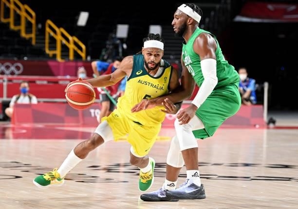 Patty Mills of Australia takes on the defence of Josh Okogie of Nigeria during the preliminary rounds of the Men's Basketball match between Australia...