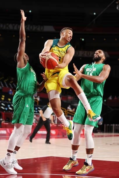 Dante Exum of Team Australia drives to the basket against Jahlil Okafor and Caleb Agada of Team Nigeria during the first half on day two of the Tokyo...