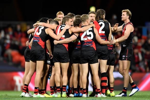 The Essendon Bombers huddle during the round 19 AFL match between Essendon Bombers and Greater Western Sydney Giants at Metricon Stadium on July 25,...