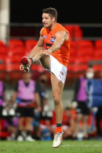Jesse Hogan of the GWS Giants kicks a goal during the round 19 AFL match between Essendon Bombers and Greater Western Sydney Giants at Metricon...