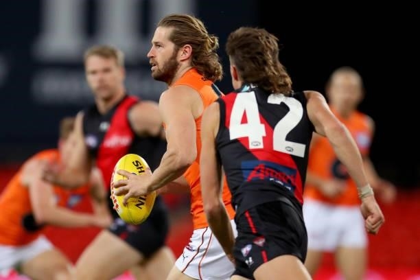 Callan Ward of the GWS Giants runs with the ball during the round 19 AFL match between Essendon Bombers and Greater Western Sydney Giants at Metricon...