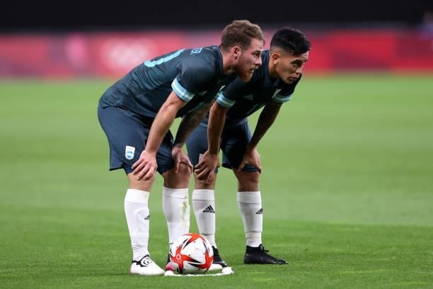 Alexis Mac Allister and Esequiel Barco of Team Argentina prepare to take a free kick during the Men's First Round Group C match between Egypt and...