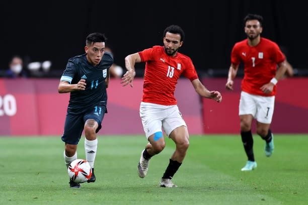 Esequiel Barco of Team Argentina runs with the ball whilst under pressure from Karim Eraky of Team Egypt during the Men's First Round Group C match...