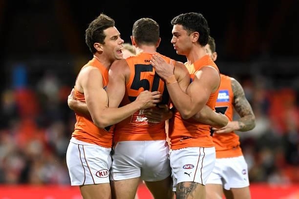 Sam J. Reid of the Giants celebrates with team mates after kicking a goal during the round 19 AFL match between Essendon Bombers and Greater Western...