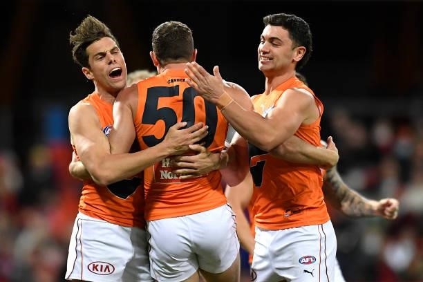 Sam J. Reid of the Giants celebrates with team mates after kicking a goal during the round 19 AFL match between Essendon Bombers and Greater Western...