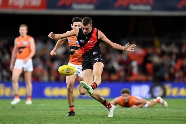 Nik Cox of the Bombers kicks the ball during the round 19 AFL match between Essendon Bombers and Greater Western Sydney Giants at Metricon Stadium on...