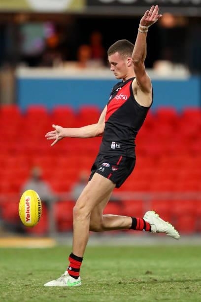Nik Cox of Essendon kicks a goal during the round 19 AFL match between Essendon Bombers and Greater Western Sydney Giants at Metricon Stadium on July...