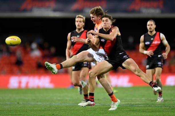 Tom Green of the Giants kicks the ball under pressure during the round 19 AFL match between Essendon Bombers and Greater Western Sydney Giants at...