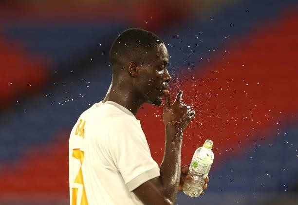 Eric Bailly of Team Ivory Coast sprays his face with water during the Men's First Round Group D match between Brazil and Cote d'Ivoire on day two of...