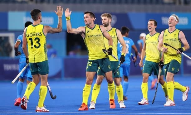 Blake Govers of Team Australia celebrates with teammates after scoring their team's fifth goal from a penalty stroke during the Men's Preliminary...
