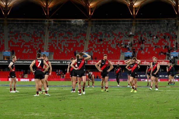 Essendon players look on after the loss during the round 19 AFL match between Essendon Bombers and Greater Western Sydney Giants at Metricon Stadium...