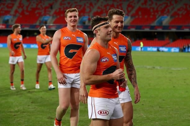 Xavier O'Halloran of the GWS Giants celebrates the win with Daniel Lloyd of the GWS Giants during the round 19 AFL match between Essendon Bombers and...