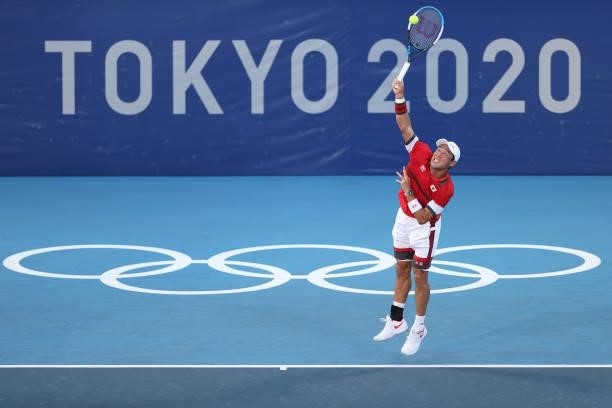 Kei Nishikori of Team Japan serves during his Men's Singles First Round match against Andrey Rublev of Team ROC on day two of the Tokyo 2020 Olympic...