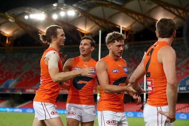 Isaac Cumming of the GWS Giants celebrates the win with Phil Davis of the GWS Giants during the round 19 AFL match between Essendon Bombers and...