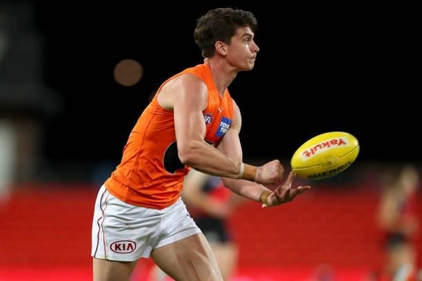 Sam Taylor of the GWS Giants handballs during the round 19 AFL match between Essendon Bombers and Greater Western Sydney Giants at Metricon Stadium...