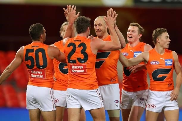 Shane Mumford of the GWS Giants celebrates his goal during the round 19 AFL match between Essendon Bombers and Greater Western Sydney Giants at...