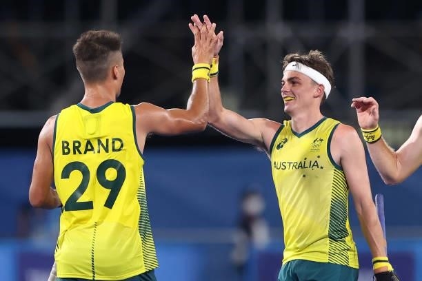 Tim Brand of Team Australia celebrates with teammate Tim Howard after scoring their team's seventh goal during the Men's Preliminary Pool A match...