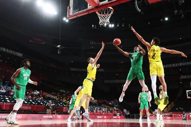 Caleb Agada of Team Nigeria drives into the lane for a layup over Josh Green and Nic Kay of Team Australia in the second half of the Men's...