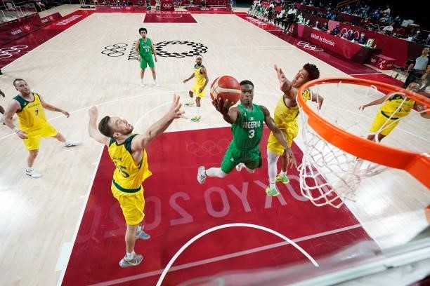 Caleb Agada of Team Nigeria drives into the lane for a layup over Josh Green and Nic Kay of Team Australia in the second half of the Men's...