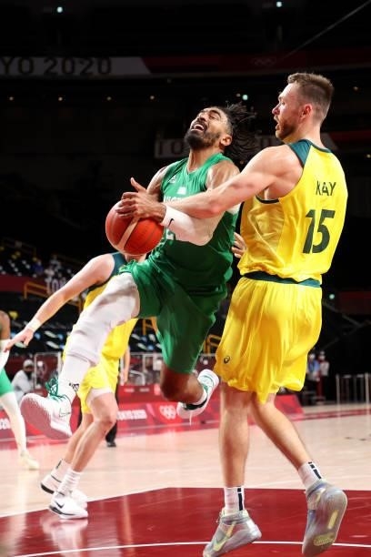 Nnamdi Vincent of Team Nigeria drives to the basket against Nic Kay of Team Australia during the second half of the Men's Preliminary Round Group B...