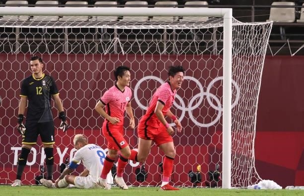 Uijo Hwang of Team South Korea celebrates after their side's first goal, an own goal scored by Marius Marin of Team Romania during the Men's Group...