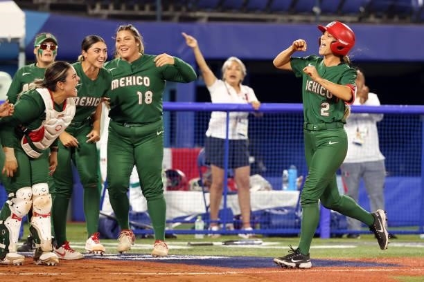 Sydney Romero of Team Mexico is congratulated by teammates at home plate after hitting a home run in the third inning against Team Italy during the...