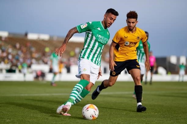 Victor Camarasa of Real Betis competes for the ball with Rayan Ait-Nouri of Wolverhampton Wanderers during a Pre Season Friendly Match between Real...