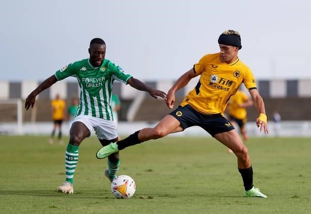 Youseff Sabaly of Real Betis competes for the ball with Raúl Jiménez of Wolverhampton Wanderers during a Pre Season Friendly Match between Real Betis...